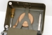 The tools of the M-209 stored in the top lid