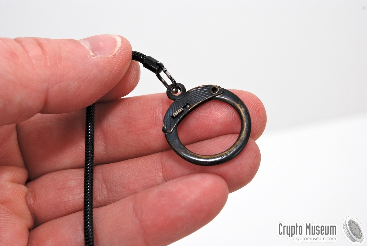 The clip at one end of the black measuring chain