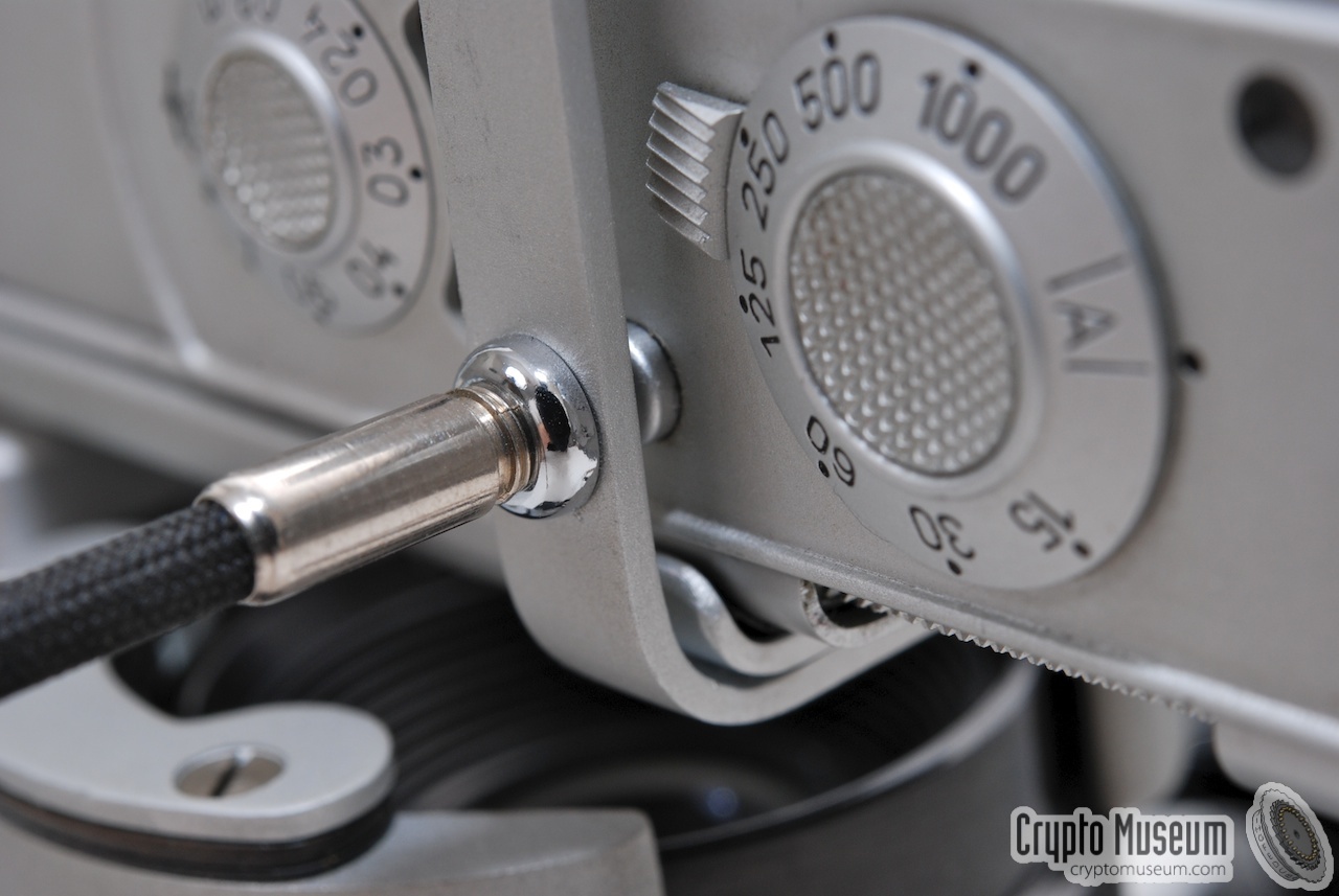 Close-up of the shutter release cable mounted in front of the shutter button.