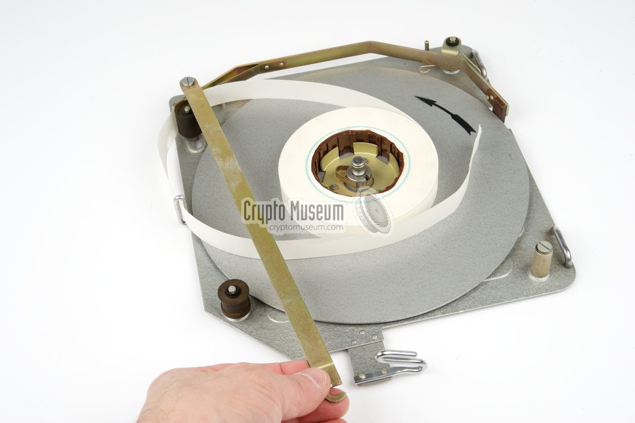 Releasing the retaining bracket for installing a fresh paper reel