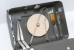 The tools are usually stored inside the top cover. At the right are the screwdriver and the tweezers. Oil and ink are on the left.