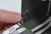 The spring-loaded bracket is moved into position by rotating it clockwise.