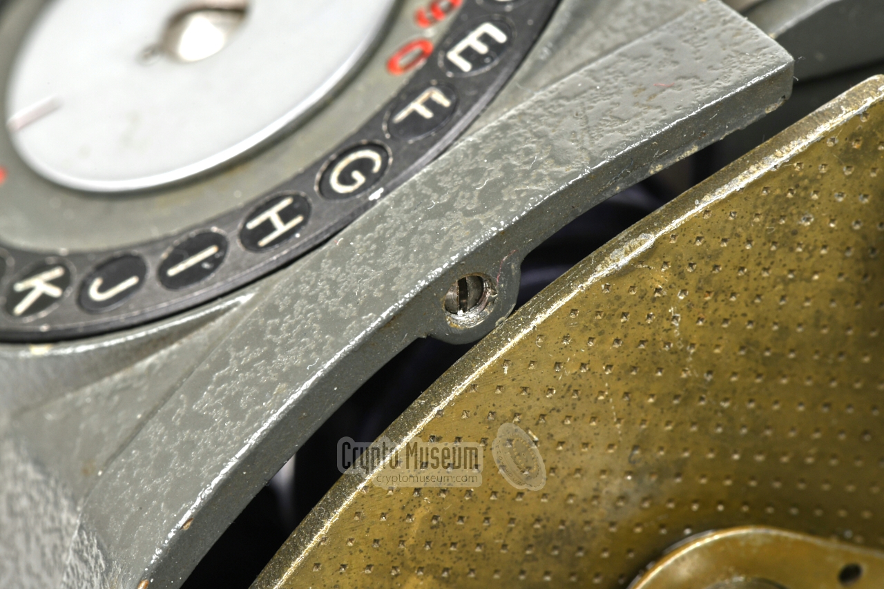 Recessed screw that holds the letter ring in place