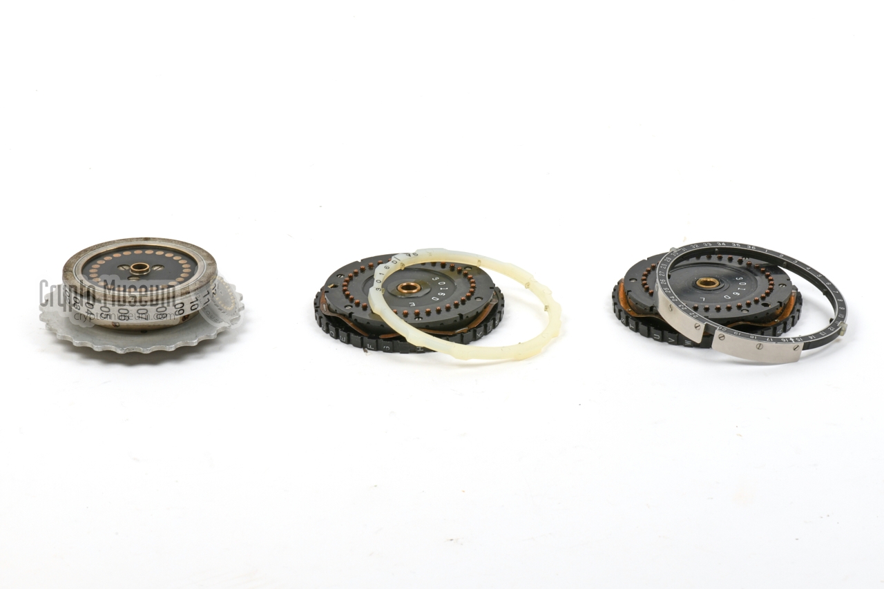 Enigma rotor (left) aside two KL-7 rotors