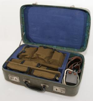 The opened suitcase, showing all Soyka parts nicely packed in canvas pockets