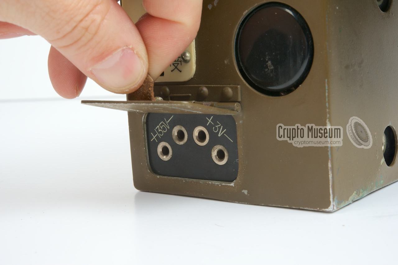 The connections for the generator, protected by a metal flap