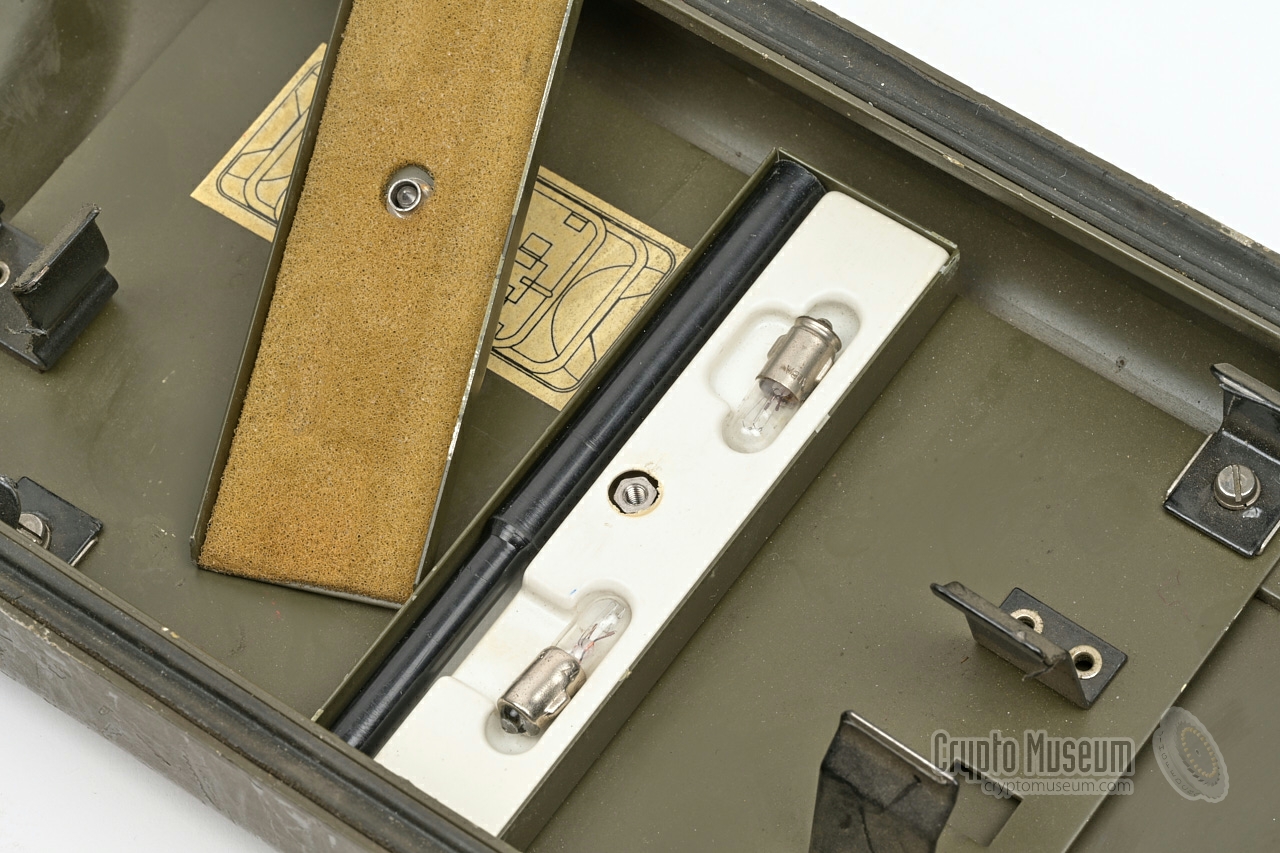 Spare lamps and lamp pulling tool, stowed inside compartment in the case lid.